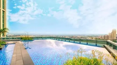 a large swimming pool on top of a building at Luxurious 2 BR at Eastwood City in Manila