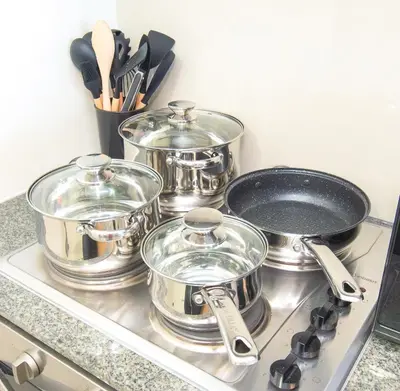 a group of pots and pans sitting on a stove at Luxury 120sqm suite Uptown BGC with spectacular balcony view in Manila