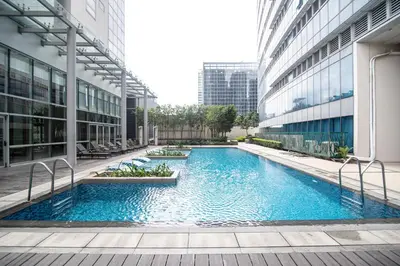 a swimming pool in the middle of a building at Luxury 120sqm suite Uptown BGC with spectacular balcony view in Manila