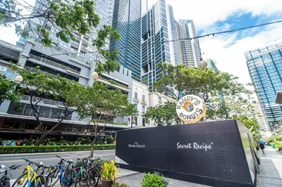 a sign in the middle of a city with buildings at Luxury 120sqm suite Uptown BGC with spectacular balcony view in Manila