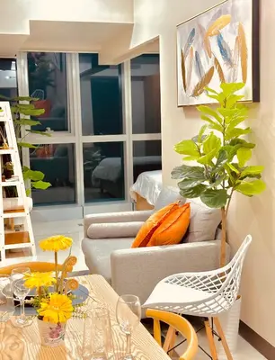 a living room with a couch and a table at 1BR Luxury unit in Uptown Parksuites -Walking distance to Malls in Manila