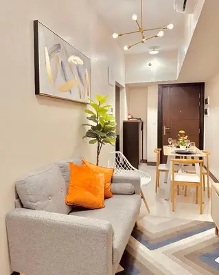 a living room with a couch and a table at 1BR Luxury unit in Uptown Parksuites -Walking distance to Malls in Manila