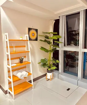 a room with a window and a shelf and a plant at 1BR Luxury unit in Uptown Parksuites -Walking distance to Malls in Manila