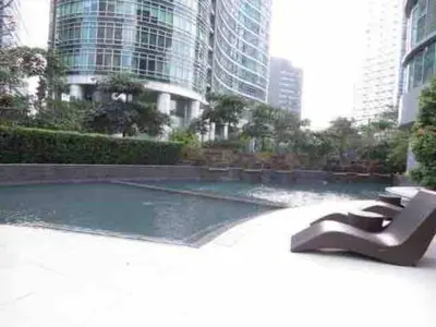 a sculpture in front of a fountain in a city at Stylish 1BR At Avant BGC in Manila
