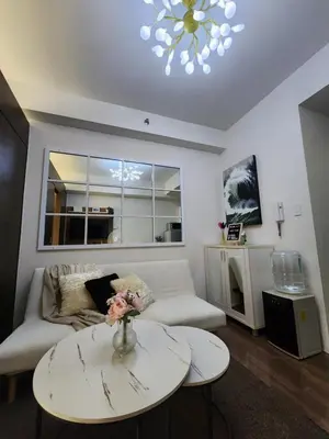 a living room with a couch and a table at Julie's Place in Manila