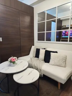 a living room with a couch and two tables at Julie's Place in Manila
