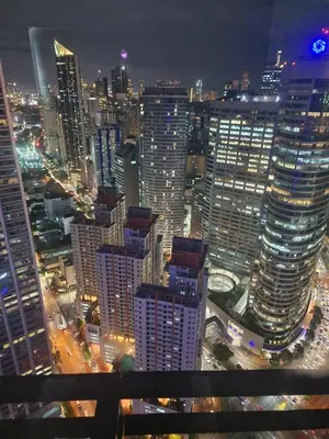 a view of a city at night with buildings at Julie's Place in Manila