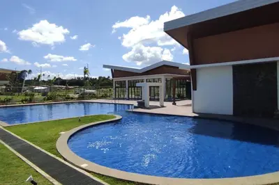 a large swimming pool in front of a building at Luxa House Staycation Tagaytay in Panungyanan