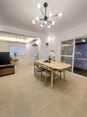 a dining room with a table and a television at Luxa House Staycation Tagaytay in Panungyanan