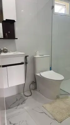 a white bathroom with a toilet and a sink at Luxa House Staycation Tagaytay in Panungyanan