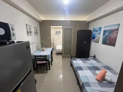 a room with two beds and a kitchen with tables at Budget SHORE Family Suite 2 Bed WiFi Netflix MOA844 in Manila