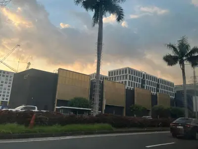 a palm tree in front of a building at Budget SHORE Family Suite 2 Bed WiFi Netflix MOA844 in Manila