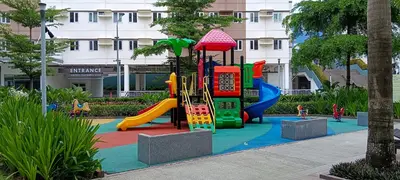 a playground in front of a building at Hope Residences by SoCaRi in Trece Martires