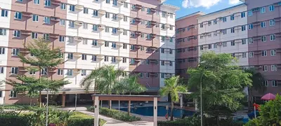 a large building with trees in front of it at Hope Residences by SoCaRi in Trece Martires