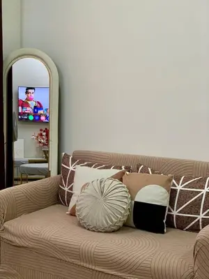 a couch with pillows on it in a living room at Hope Residences by SoCaRi in Trece Martires