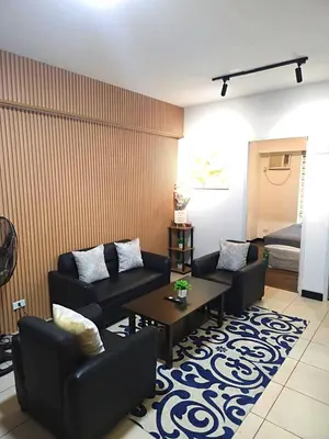 a living room with two couches and a coffee table at lea home flair tower staycation mandaluyong in Manila