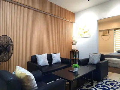 a living room with a couch and a table at lea home flair tower staycation mandaluyong in Manila