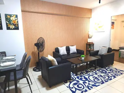 a living room with a couch and a table at lea home flair tower staycation mandaluyong in Manila