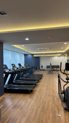 a gym with a row of treadles in a room at Prestige Suite at Tulip Gardens Southwoods in Jalang