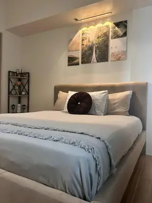 a bedroom with a large bed with areath on it at Prestige Suite at Tulip Gardens Southwoods in Jalang