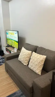 a brown couch with two pillows in a living room at Prestige Suite at Tulip Gardens Southwoods in Jalang