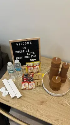 a table with a welcome to prestige shuttle sign and cupcakes at Prestige Suite at Tulip Gardens Southwoods in Jalang