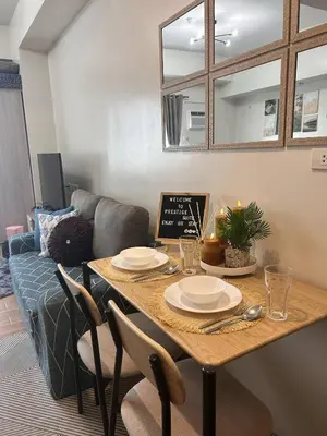 a living room with a table and a couch at Prestige Suite at Tulip Gardens Southwoods in Jalang