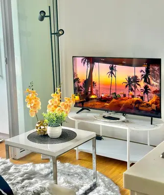 a living room with a large flat screen tv at 1BR Acqua Residences ,Mandaluyong just 3-5 mins to Makati district in Manila