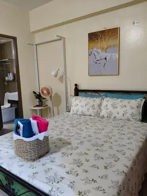 a bedroom with a bed with a basket on it at LDN 5J - Condotel Newport in Manila