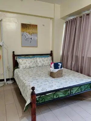 a bedroom with a bed with a basket on it at LDN 5J - Condotel Newport in Manila