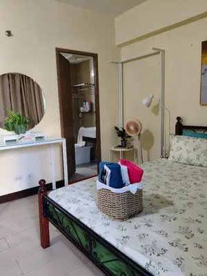 a bedroom with a bed with a basket on it at LDN 5J - Condotel Newport in Manila