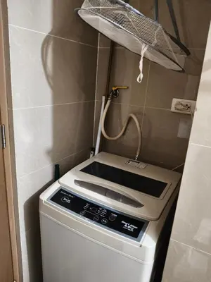 a kitchen with a stove and a basket on the wall at LDN 5J - Condotel Newport in Manila