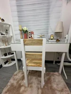 a white desk with a chair in a room at Elyana's Staycation in Pasalada