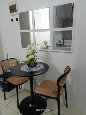 a table and chairs in a room with a window at Nics Condotel - Mandaluyong Along Edsa in Manila