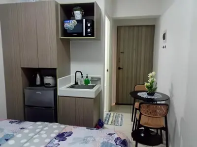 a small kitchen with a sink and a table at Nics Condotel - Mandaluyong Along Edsa in Manila