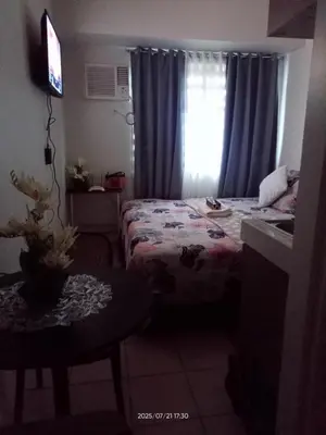 a small room with a bed and a window at Nics Condotel - Mandaluyong Along Edsa in Manila