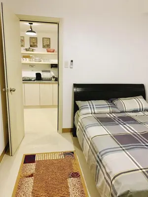 a bedroom with a bed and a rug on the floor at 2br condo in Southmall Las Pinas 25 mins to NAIA - 709T3 in Manila