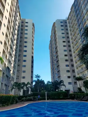 a pool in front of two apartment buildings at 2br condo in Southmall Las Pinas 25 mins to NAIA - 709T3 in Manila