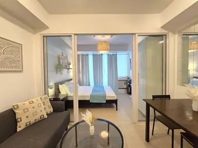 a living room with a couch and a bed in a room at 1BR Condotel at Azure Urban Resort Near Airport #AZ05 in Manila