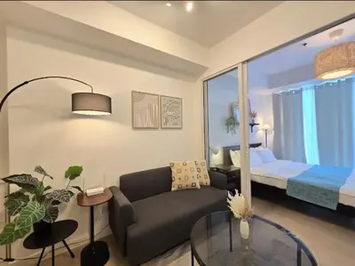 a living room with a couch and a bedroom at 1BR Condotel at Azure Urban Resort Near Airport #AZ05 in Manila