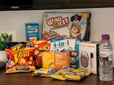 a pile of snacks and games on a table at 1BR Condotel at Azure Urban Resort Near Airport #AZ05 in Manila