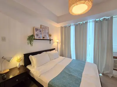 a bedroom with a bed and a large window at 1BR Condotel at Azure Urban Resort Near Airport #AZ05 in Manila