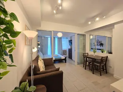 a living room with a couch and a table at 1BR Condotel at Azure Urban Resort Near Airport #AZ06 in Manila