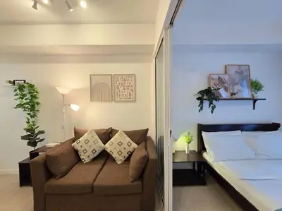 a living room with a couch and a bed at 1BR Condotel at Azure Urban Resort Near Airport #AZ06 in Manila