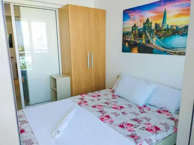 a bedroom with a bed with pink flowers on it at Cozy 2 Bedroom With Blacony in Manila