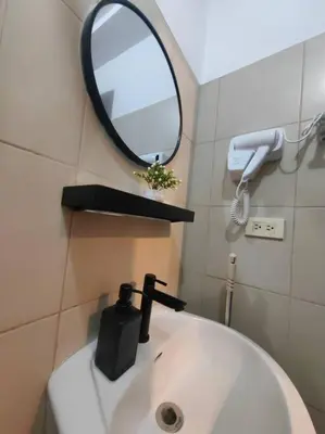 a bathroom with a sink and a mirror on the wall at 1BR Condotel Ridgewood Towers Taguig City #RW15 in Manila