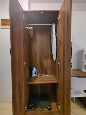 a wooden cabinet with shoes in a room at 1BR Condotel Ridgewood Towers Taguig City #RW15 in Manila