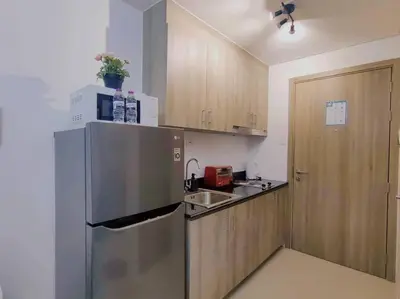 a kitchen with a stainless steel refrigerator and a sink at 1BR Condotel with Balcony at FAME Residences #FM36 in Manila