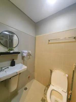 a bathroom with a toilet and a sink at 1BR Condotel with Balcony at FAME Residences #FM37 in Manila