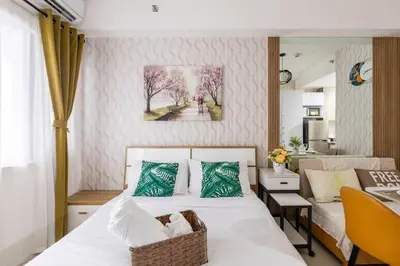 a bedroom with a bed and a desk and a painting at Hotel style Unit 2924 Fame in Manila